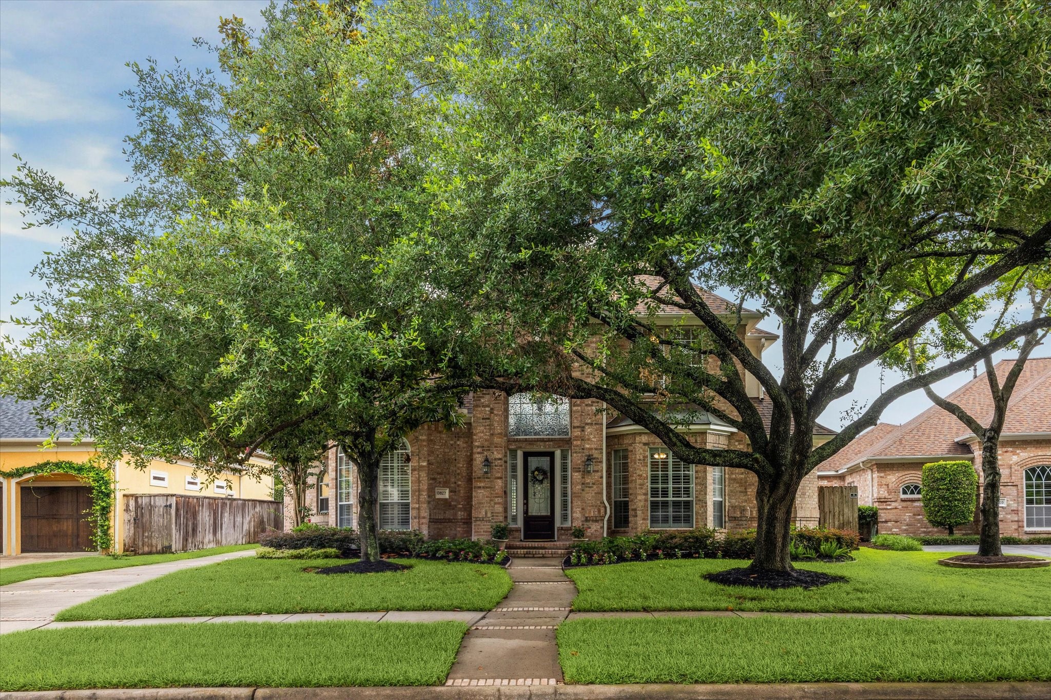 13627 Ashley Run Houston, TX 77077 - Photo 2 of 30 a front view of a house with a yard
