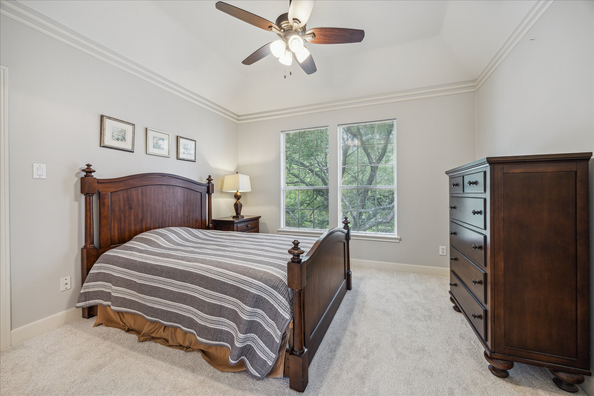 13627 Ashley Run Houston, TX 77077 - Photo 24 of 30 a bedroom with a bed and a chandelier