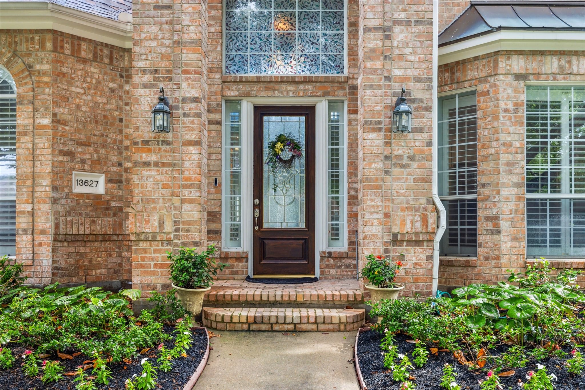 13627 Ashley Run Houston, TX 77077 - Photo 4 of 30 front door of a brick house with a small yard