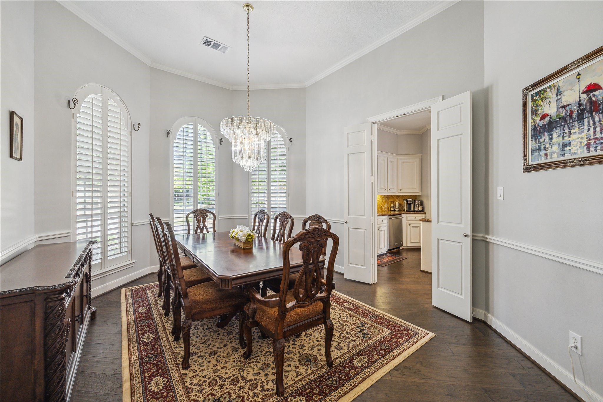 13627 Ashley Run Houston, TX 77077 - Photo 7 of 30 a dining room with furniture a chandelier and wooden floor