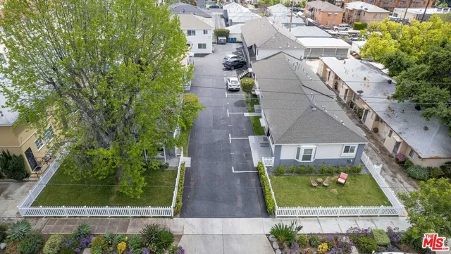 an aerial view of residential houses with outdoor space