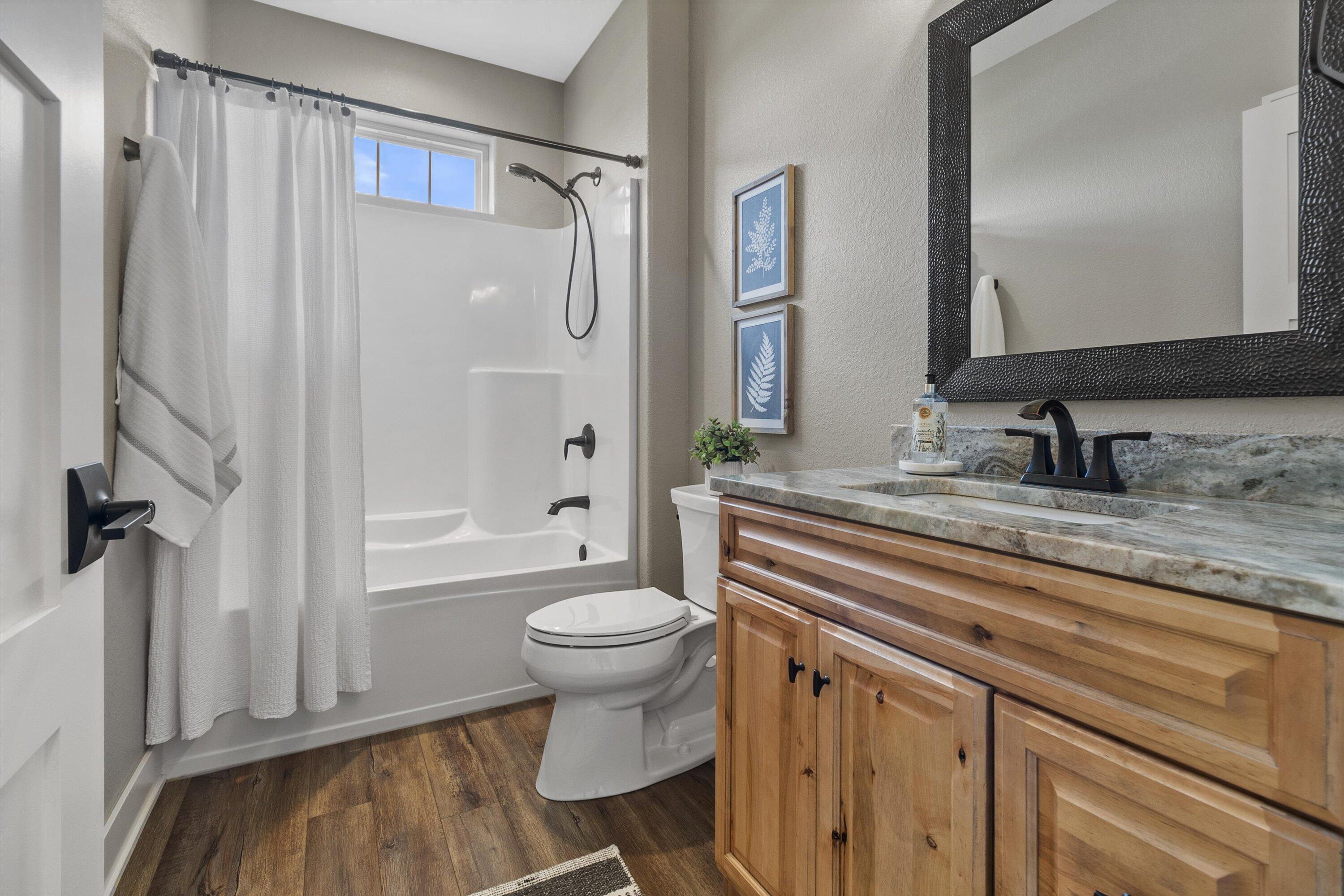 S75W35724 Wilton Road Eagle, WI 53119 - Photo 33 of 63 The transom window above the shower/tub really add an element of nature in this space.