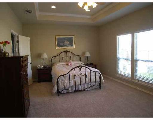 6542 Lens Drive Corpus Christi, TX 78414 - Photo 3 of 8 a bedroom with a bed lamp and a window