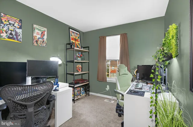 a view of a workspace with furniture and a window