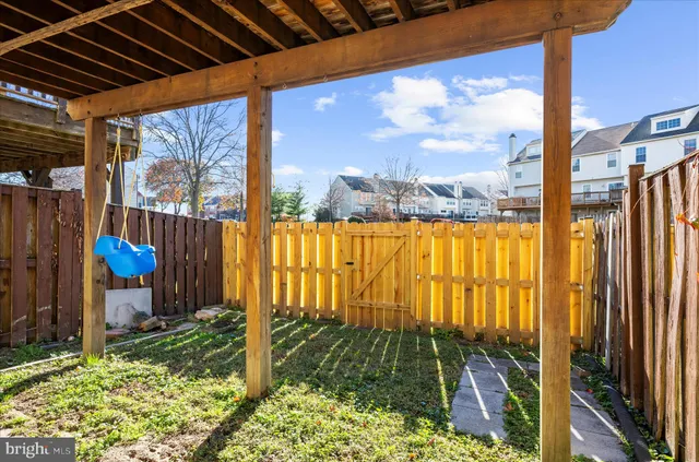 a view of a house with wooden deck and furniture