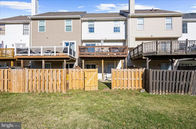 an aerial view of a house with swimming pool and outdoor seating