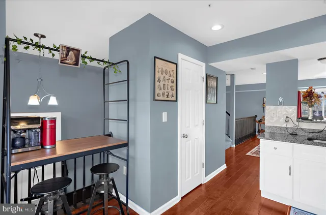 a kitchen with stainless steel appliances granite countertop white cabinets a stove a microwave and a refrigerator