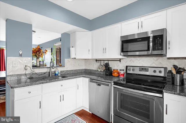 a kitchen with a stove a microwave and a refrigerator