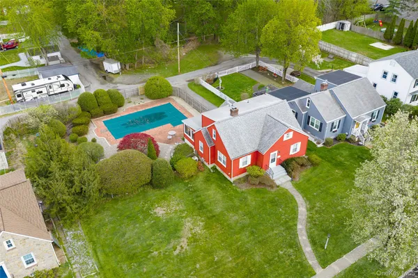 an aerial view of a pool patio chairs and fire pit