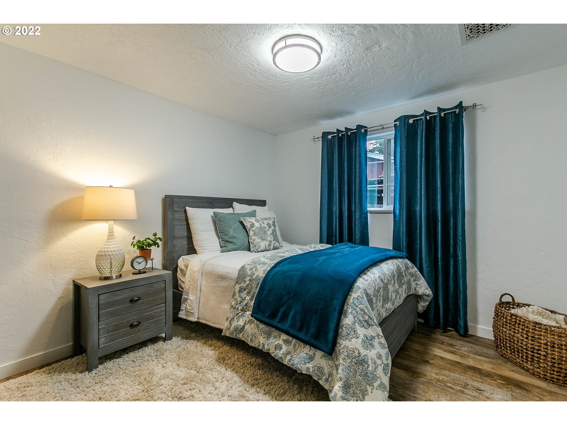 1597 Balboa Street Eugene, OR 97408 - Photo 11 of 27 a bedroom with a bed and a lamp