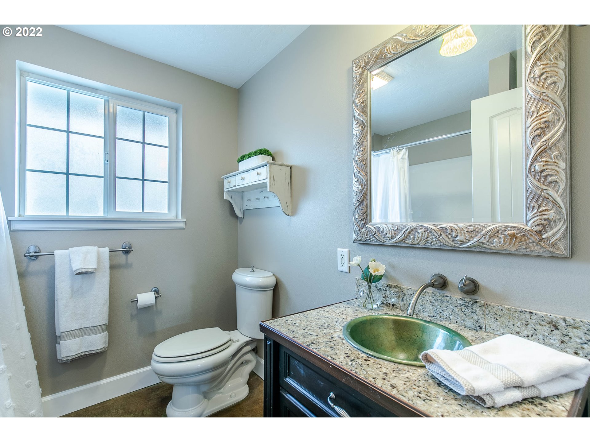 1597 Balboa Street Eugene, OR 97408 - Photo 17 of 27 a bathroom with a granite countertop toilet a sink and mirror