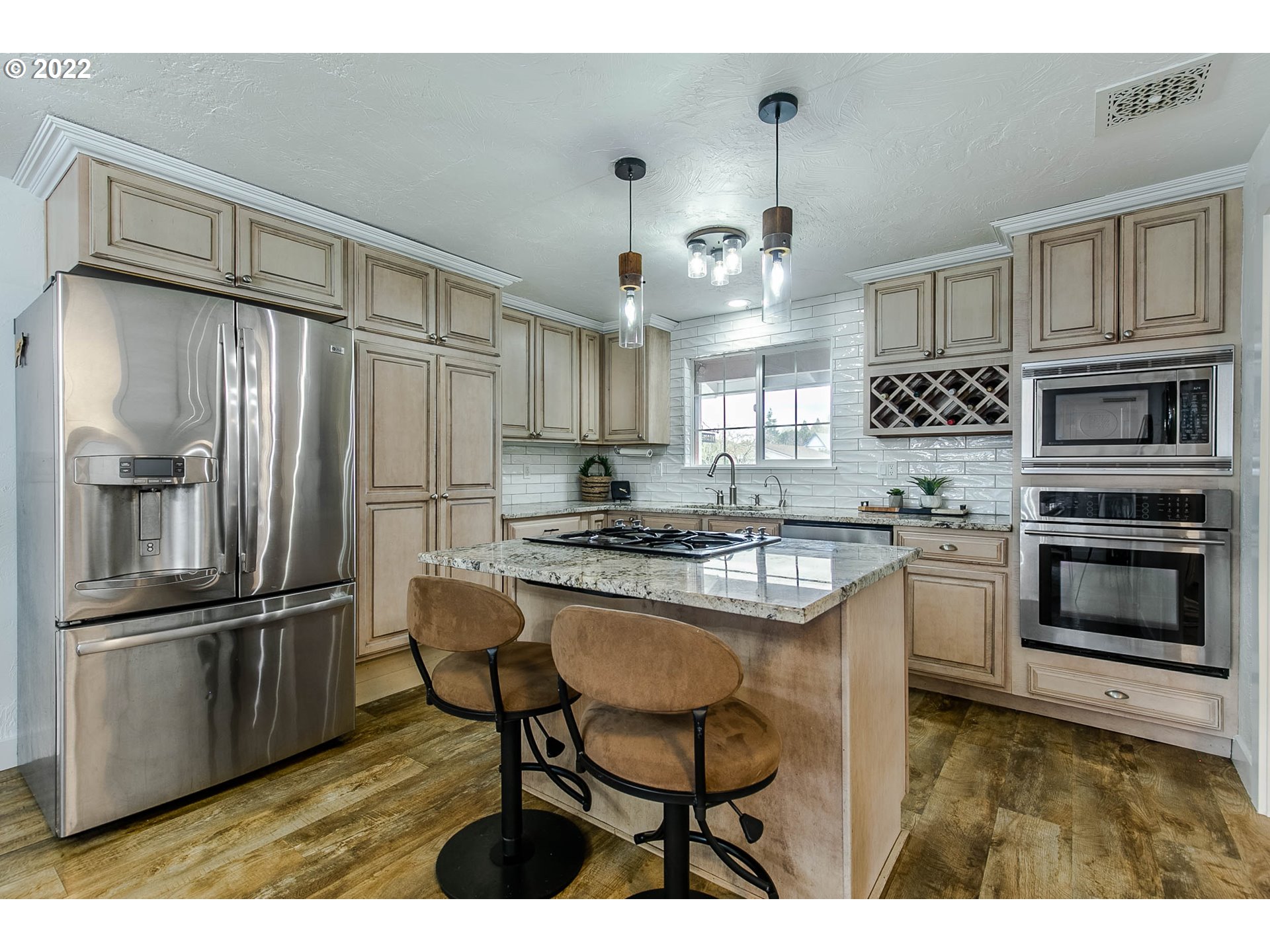 1597 Balboa Street Eugene, OR 97408 - Photo 5 of 27 a kitchen with kitchen island white cabinets and stainless steel appliances