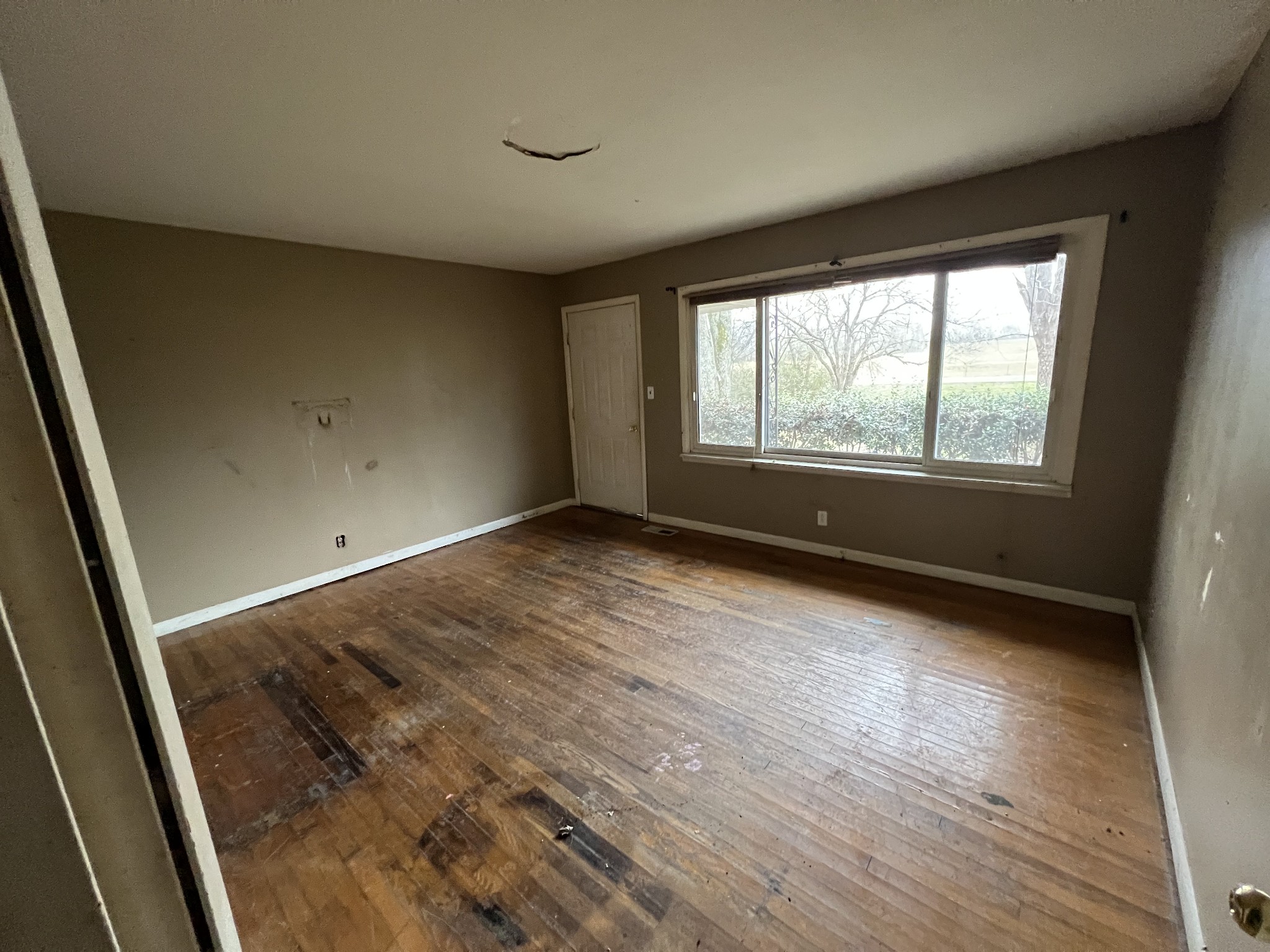 31155 Ardmore Ridge Road Ardmore, TN 38449 - Photo 16 of 23 a view of an empty room with wooden floor and a window