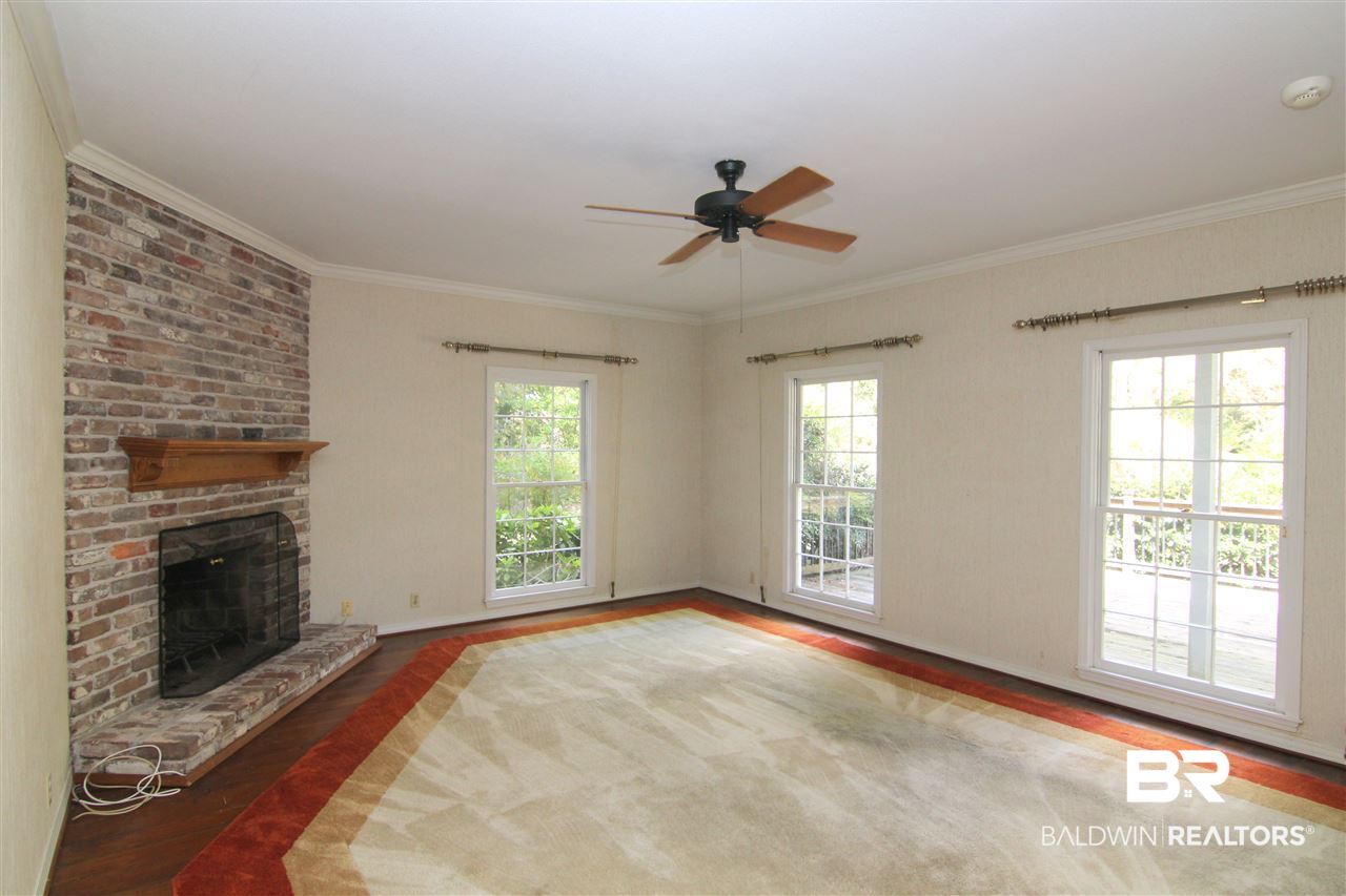 7147 Chapman Street Fairhope, AL 36532 - Photo 5 of 48 FP & hardwood flrs. That is a rug; not carpet.