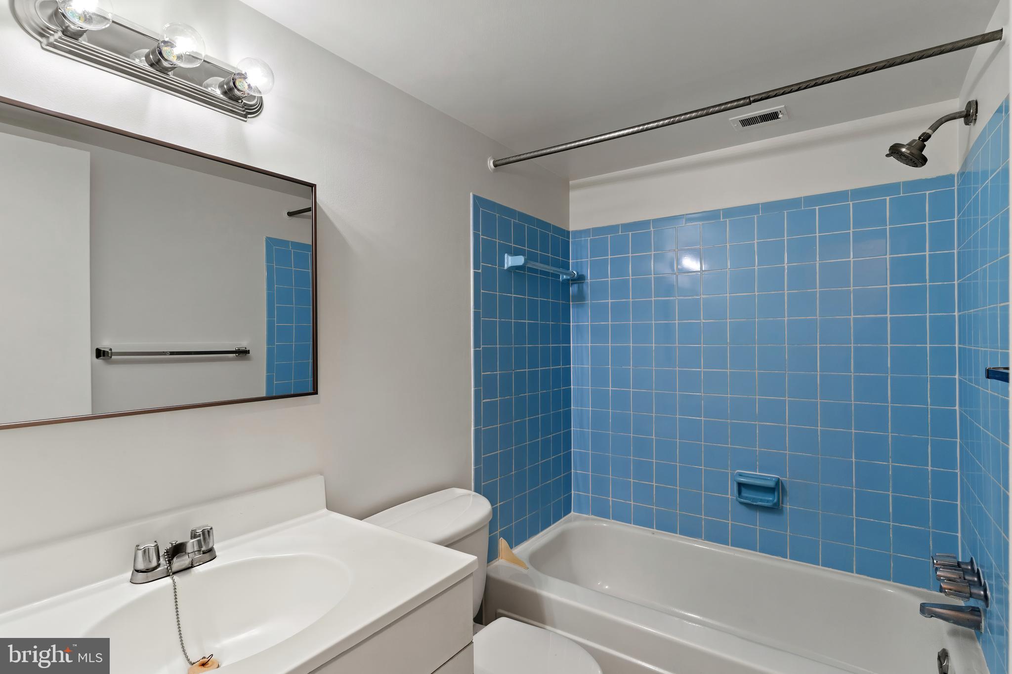 3362 Woodburn Road, Unit 13 Annandale, VA 22003 - Photo 11 of 17 a bathroom with a bathtub a sink a toilet and a mirror