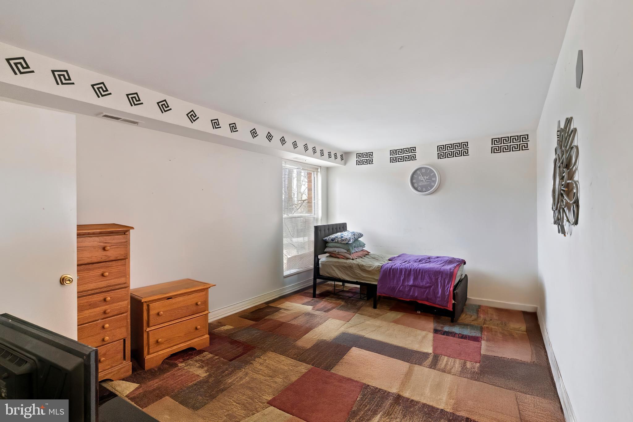 3362 Woodburn Road, Unit 13 Annandale, VA 22003 - Photo 12 of 19 a bedroom with furniture and a baby crib