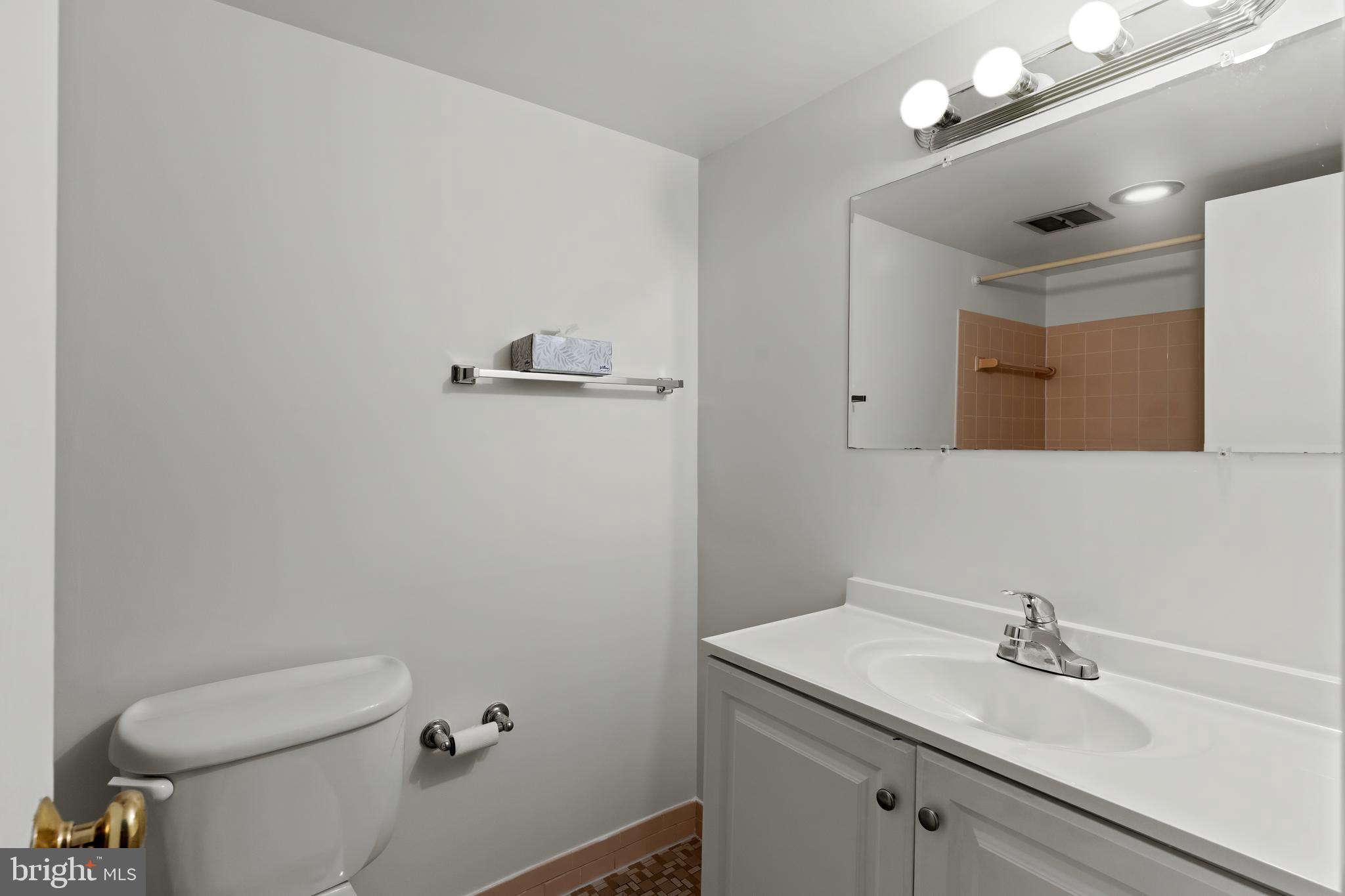 3362 Woodburn Road, Unit 13 Annandale, VA 22003 - Photo 13 of 17 a bathroom with a sink vanity and a toilet