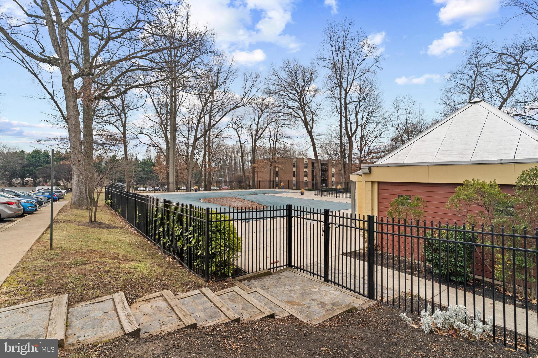 3362 Woodburn Road, Unit 13 Annandale, VA 22003 - Photo 17 of 17 a view of a pathway with a wrought fence