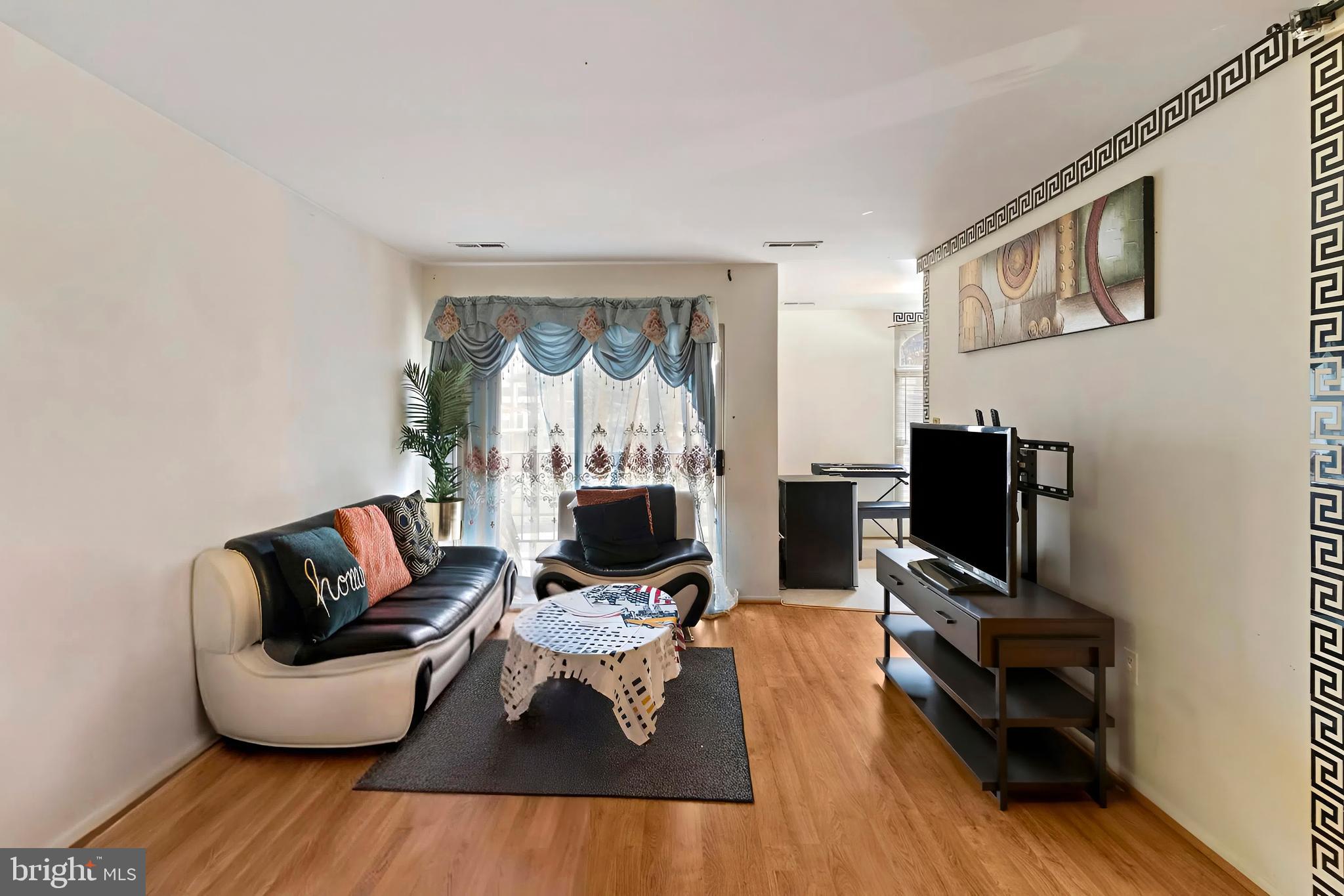 3362 Woodburn Road, Unit 13 Annandale, VA 22003 - Photo 4 of 19 a living room with furniture and a flat screen tv