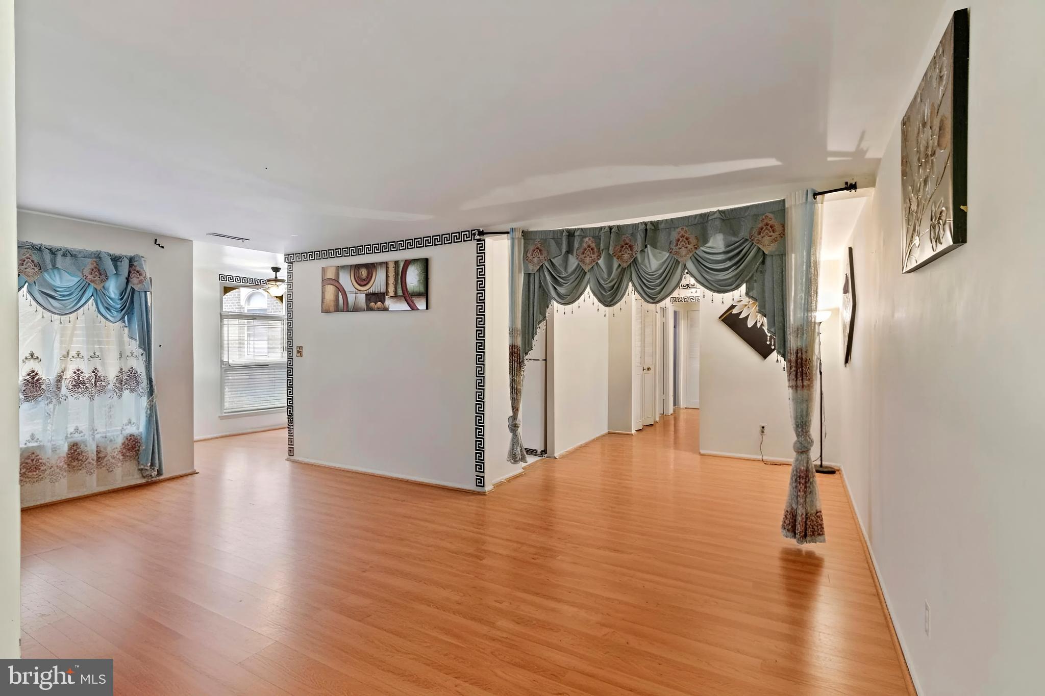 3362 Woodburn Road, Unit 13 Annandale, VA 22003 - Photo 5 of 19 a view of an empty room with wooden floor and a window