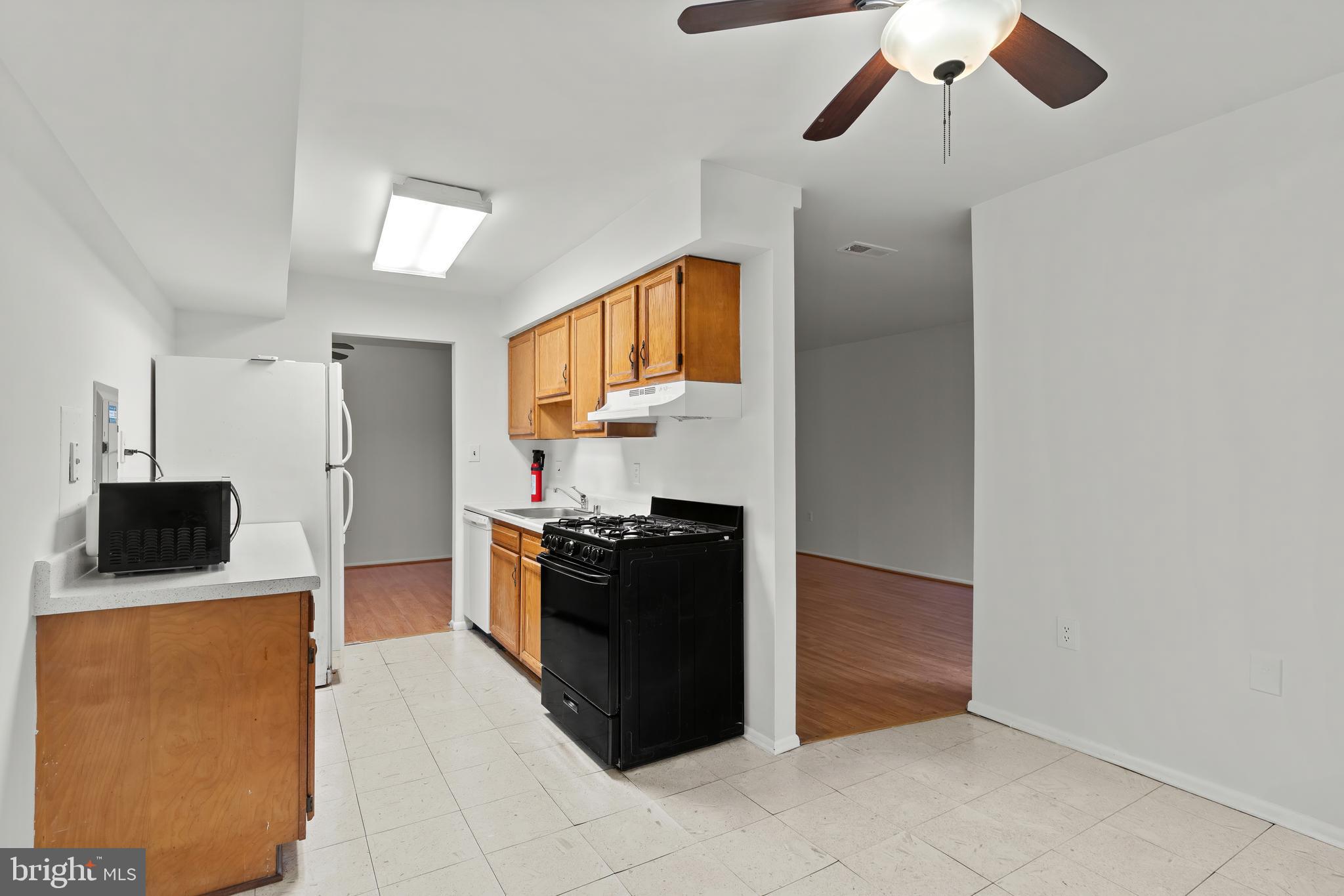 3362 Woodburn Road, Unit 13 Annandale, VA 22003 - Photo 5 of 17 a kitchen with stainless steel appliances granite countertop a refrigerator and a stove top oven