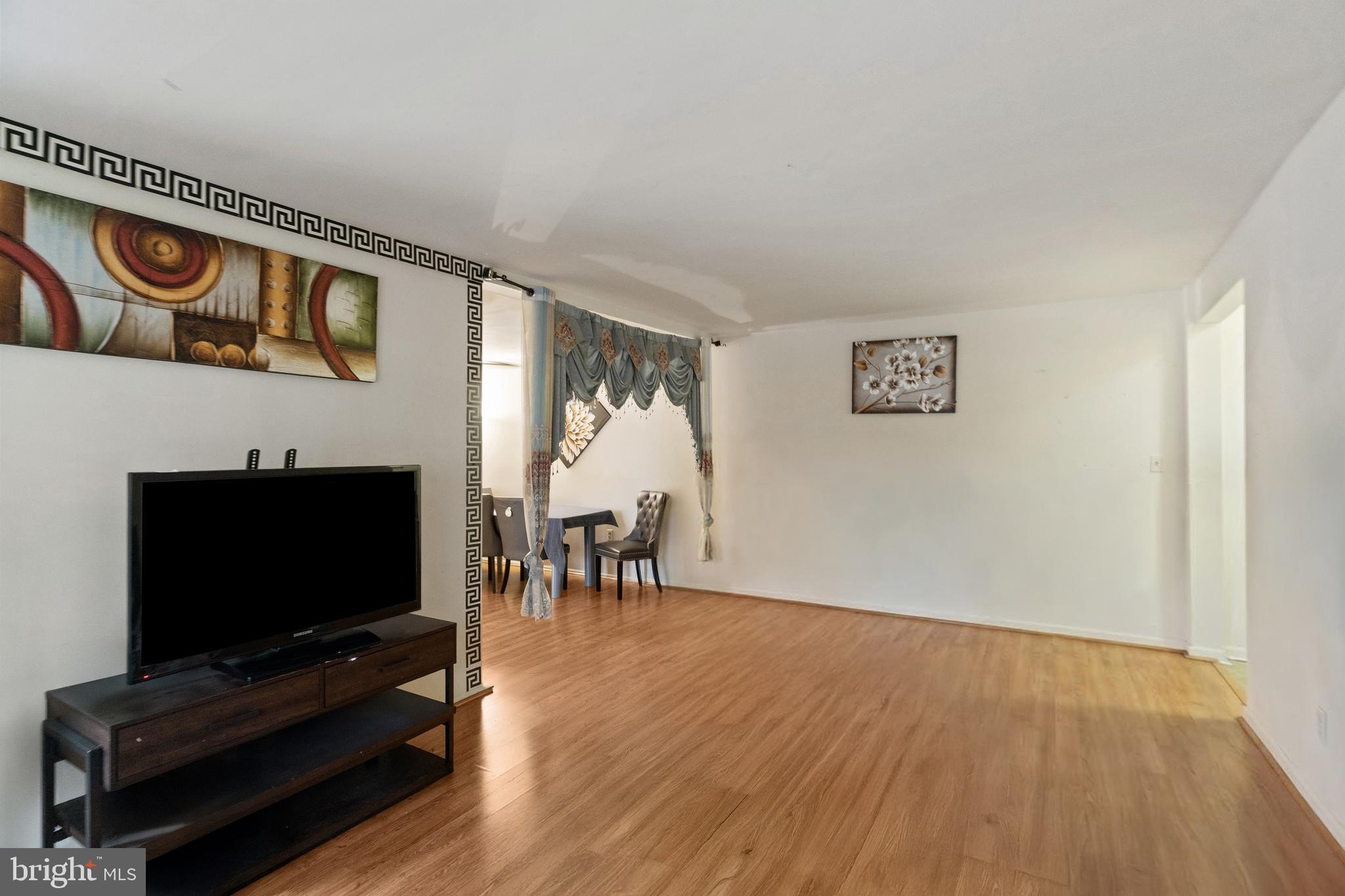 3362 Woodburn Road, Unit 13 Annandale, VA 22003 - Photo 7 of 19 a living room with furniture and a flat screen tv