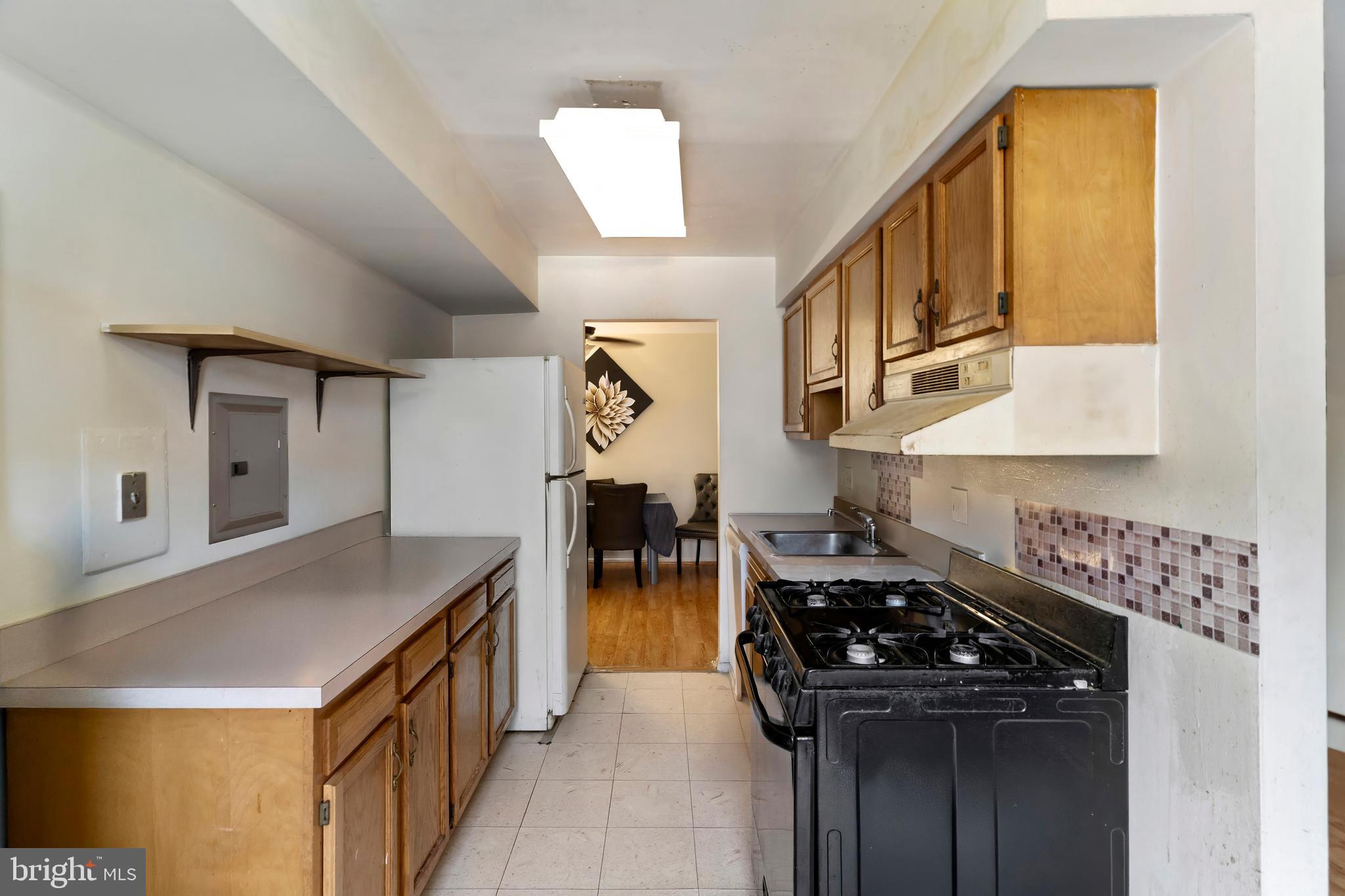 3362 Woodburn Road, Unit 13 Annandale, VA 22003 - Photo 10 of 19 a kitchen with stainless steel appliances a stove a sink and a refrigerator