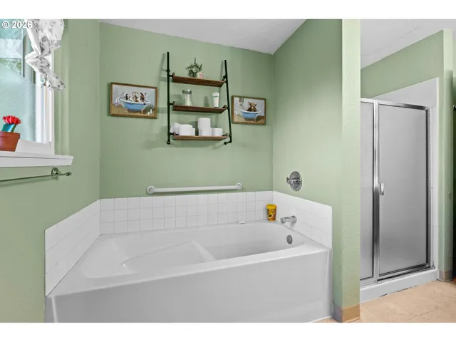 a white bath tub sitting next to a white wall