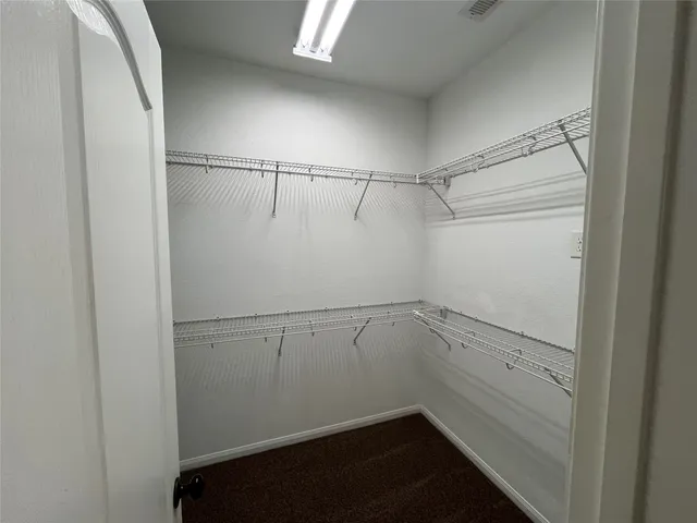 a view of an empty walk in closet