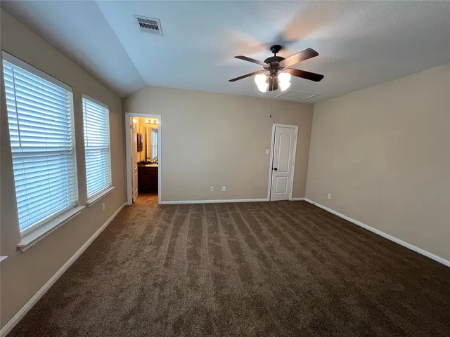 a view of a livingroom with a ceiling fan and window