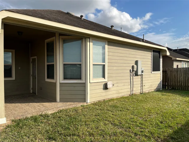 a view of a house with a backyard