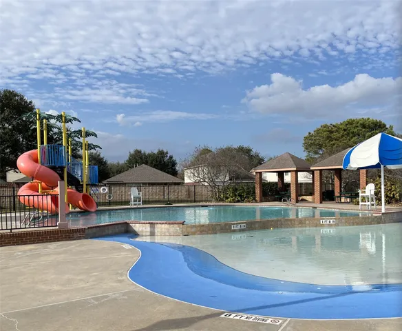 a view of a swimming pool with a patio