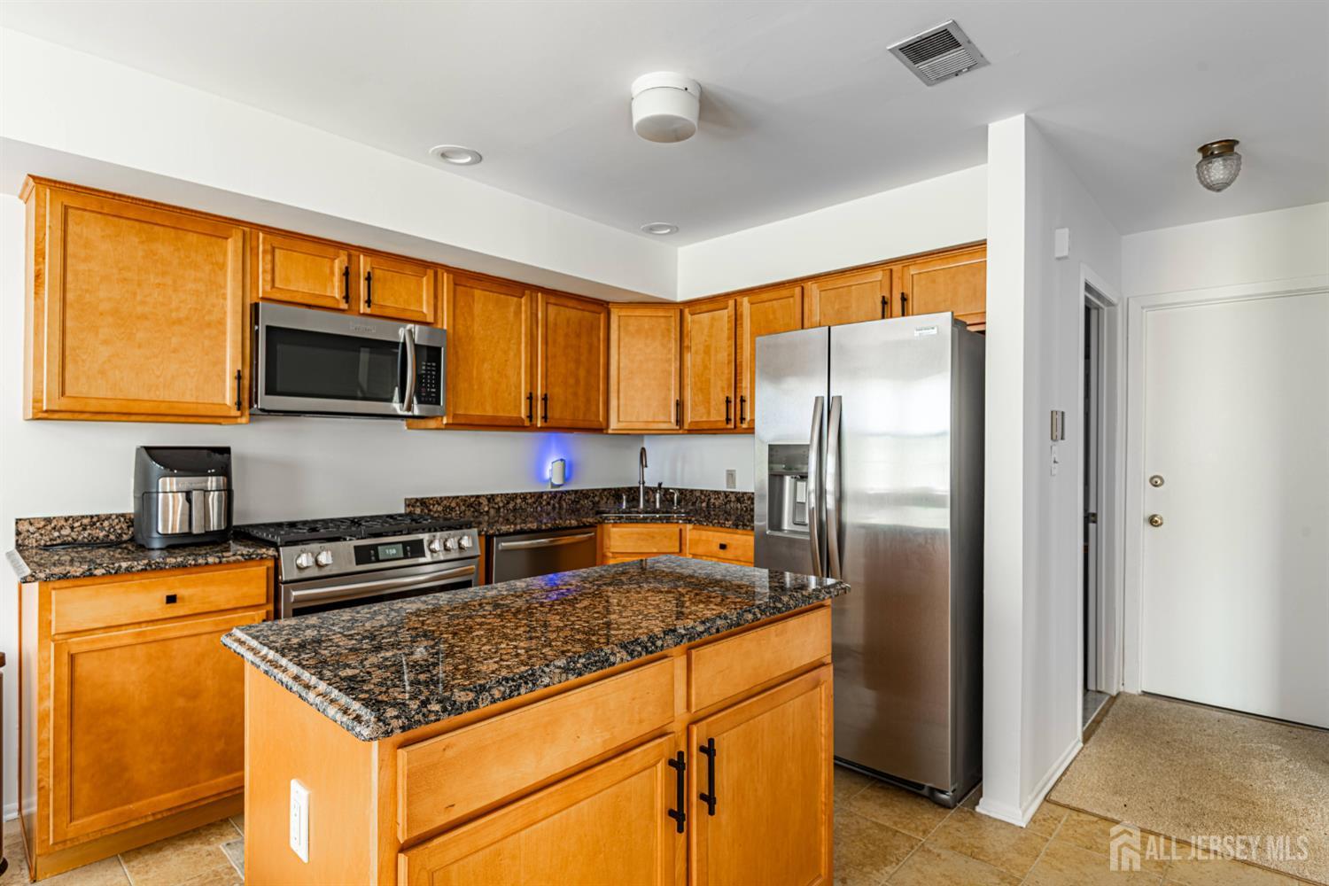 328 Lunar Road Piscataway, NJ 08854 - Photo 3 of 18 a kitchen with stainless steel appliances granite countertop a refrigerator stove top oven a sink and dishwasher