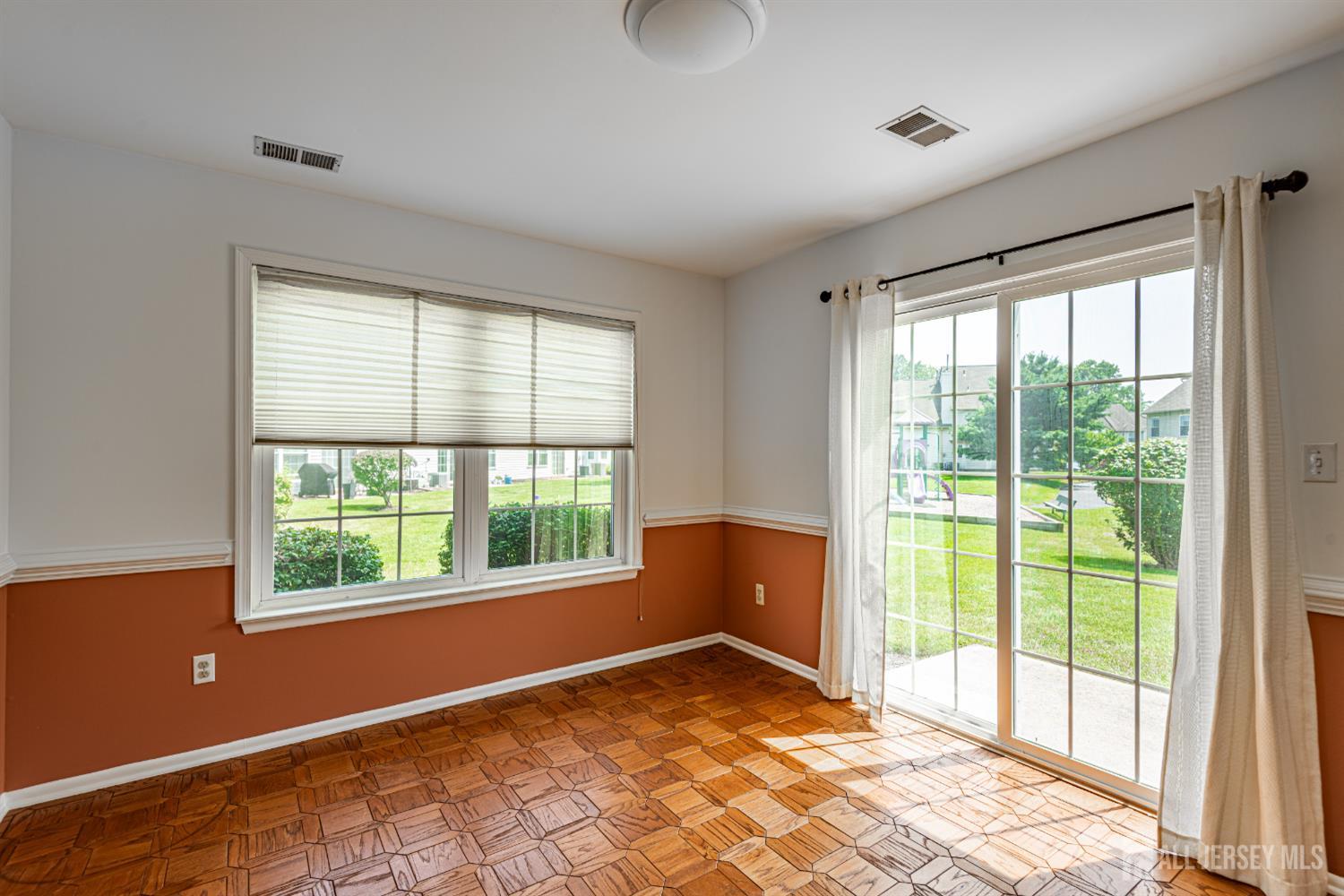 328 Lunar Road Piscataway, NJ 08854 - Photo 4 of 18 a view of an empty room with wooden floor and a window