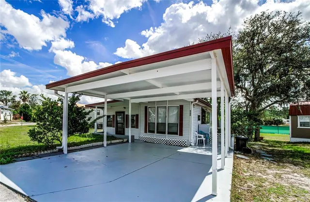 a view of a building with a porch and a yard