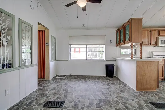 a view of a kitchen with furniture and windows