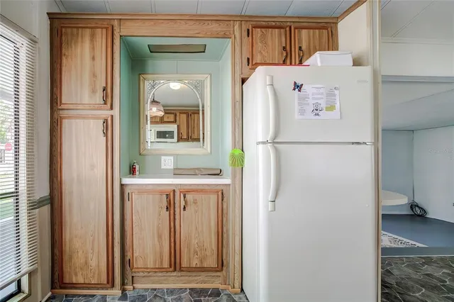a white refrigerator freezer and a window in a kitchen
