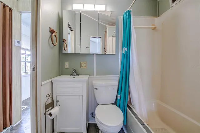 a white toilet sitting next to a bathroom sink