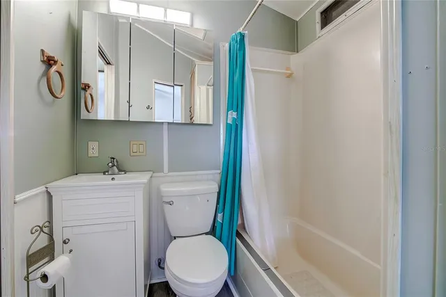 a bathroom with a toilet sink and shower