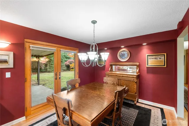 a dining room with furniture a chandelier and window