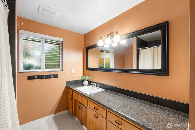 a bathroom with a double vanity sink and a mirror