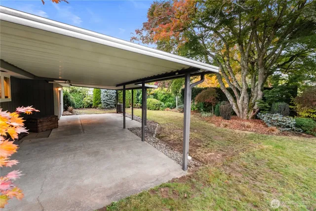 a view of a backyard with table and chairs under an umbrella