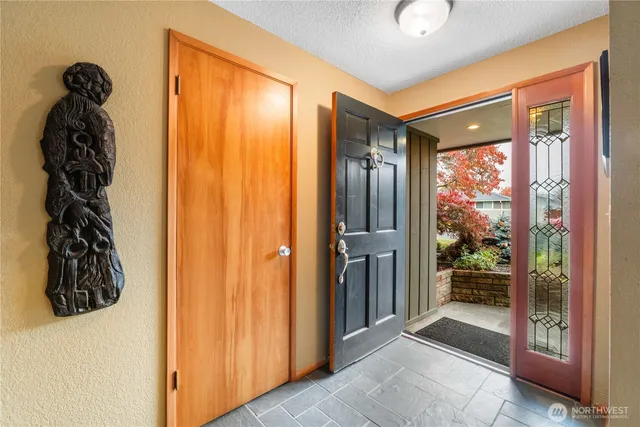 a view of hallway with furniture and a large window