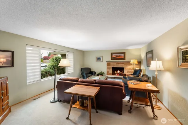 a living room with fireplace furniture and a window