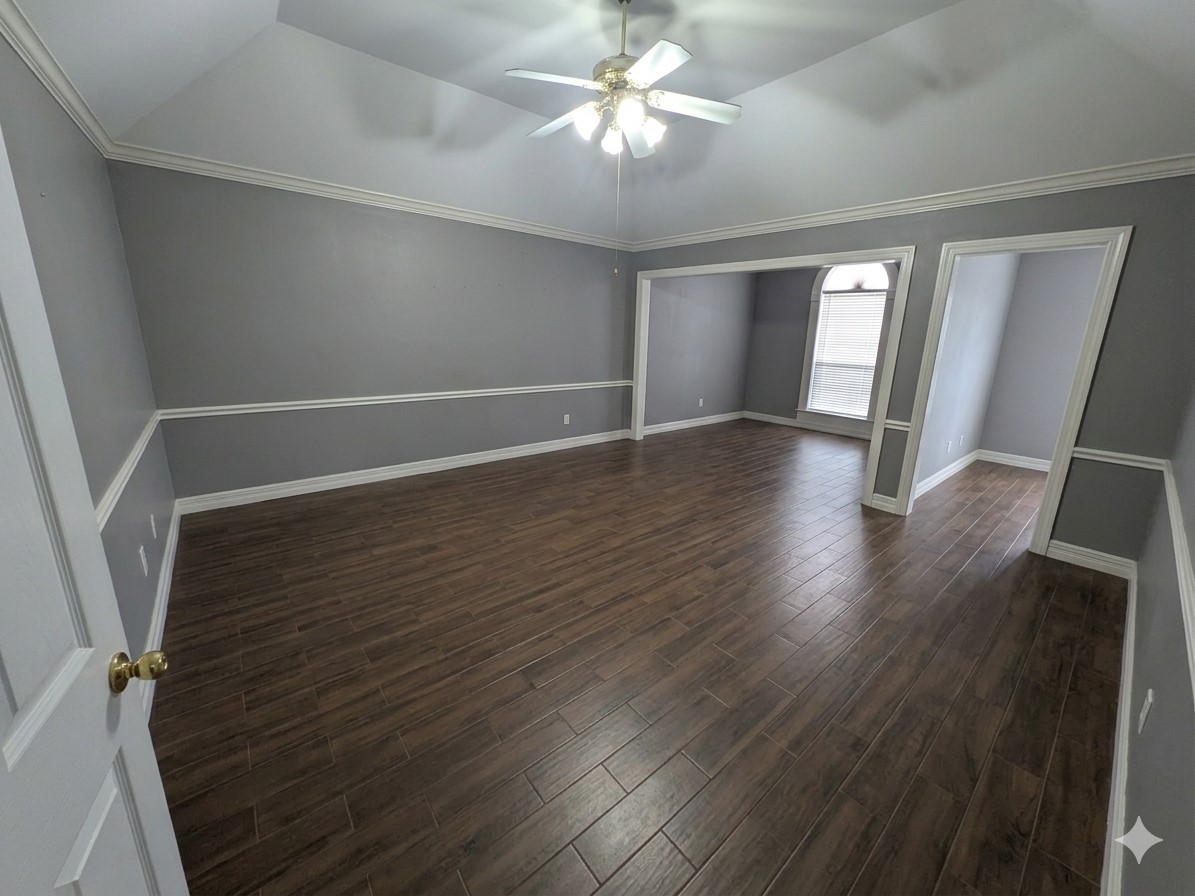 13107 Walnut Lake Road Houston, TX 77065 - Photo 16 of 21 an empty room with wooden floor and windows