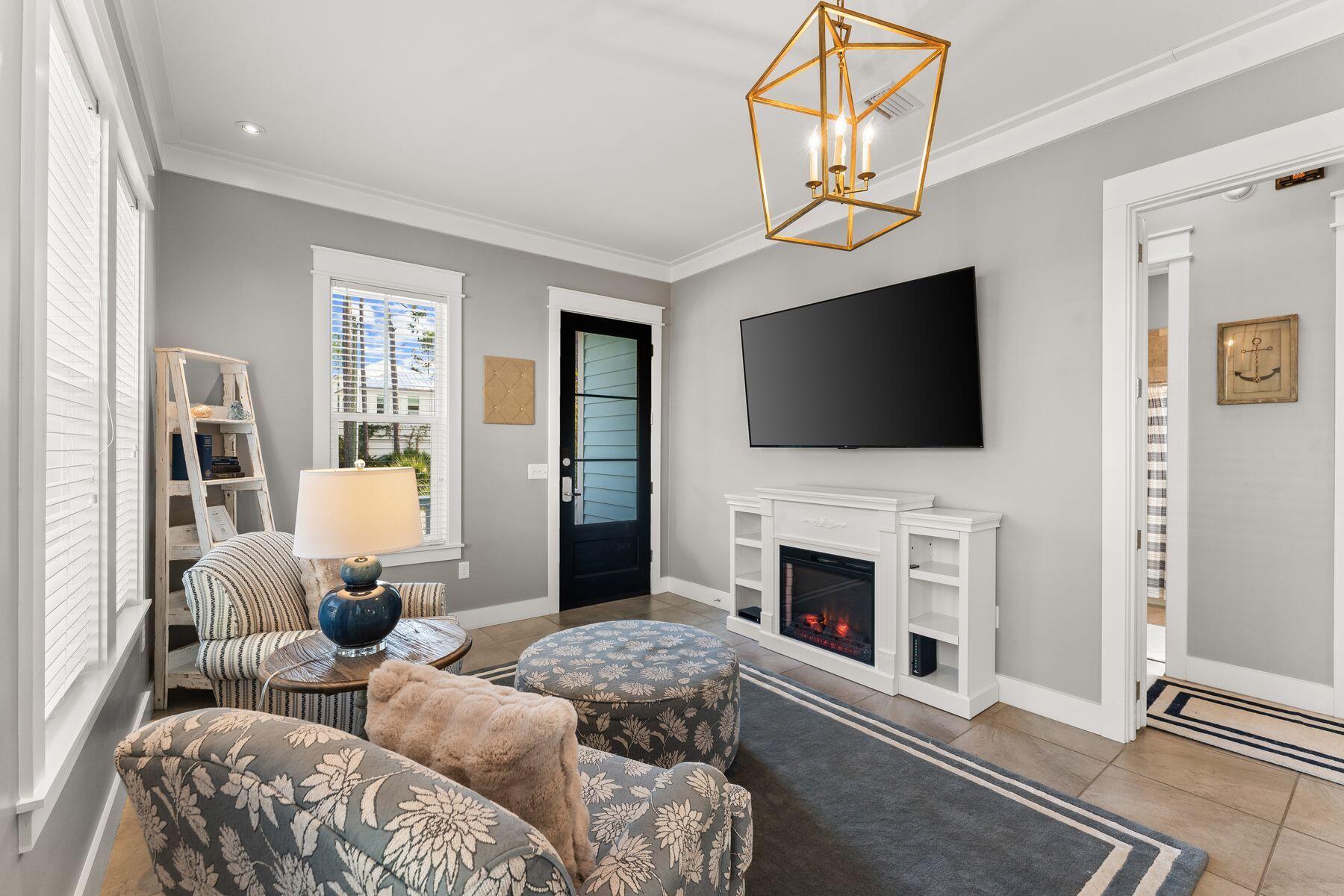 a living room with furniture a fireplace and a flat screen tv