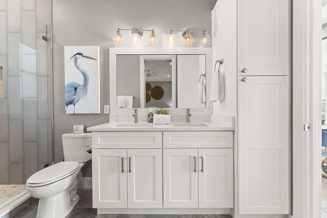 a bathroom with a toilet sink and mirror
