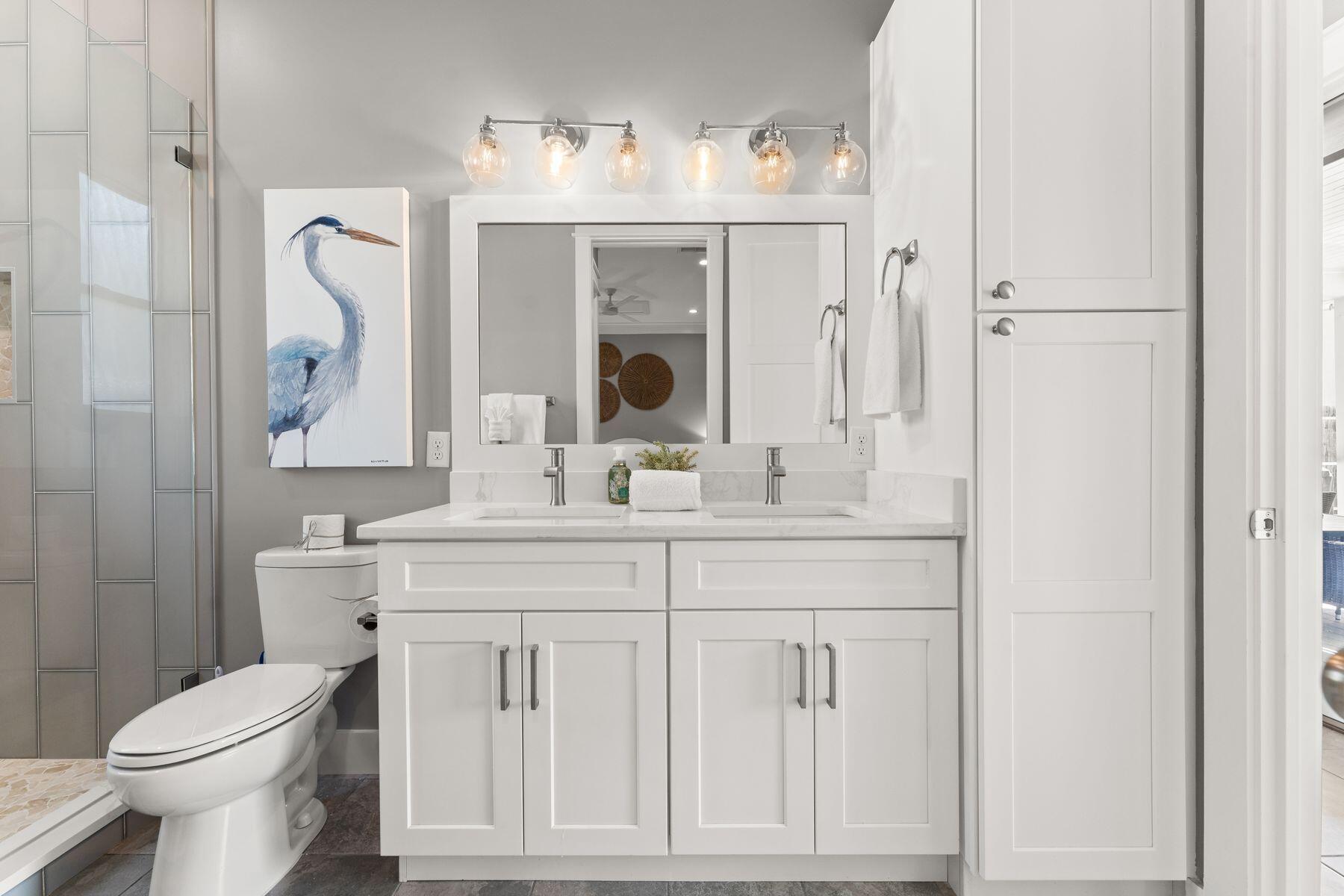 389 Seacrest Drive Seacrest, FL 32461 - Photo 15 of 33 a bathroom with a toilet sink and mirror