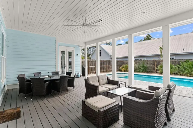 a living room with furniture and large windows