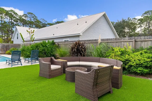a view of a couches in patio of back yard